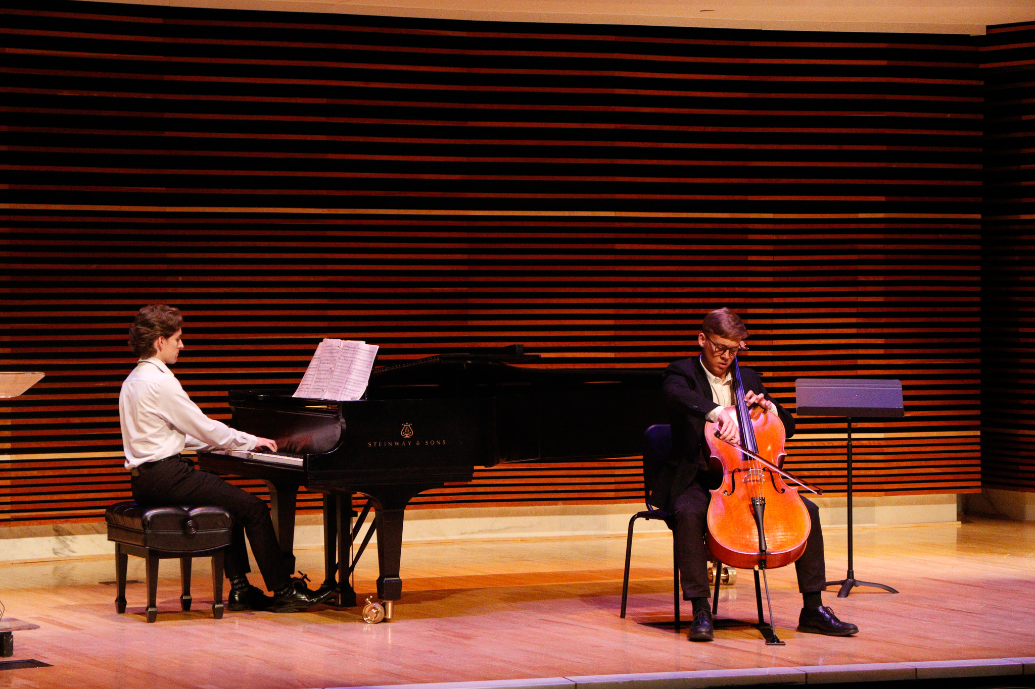 Photo of pianist alongside cellist on stage