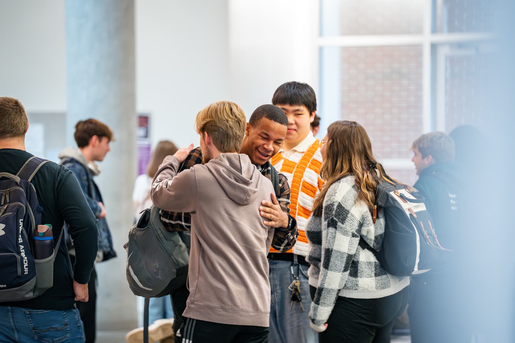 Students hugging in the lobby