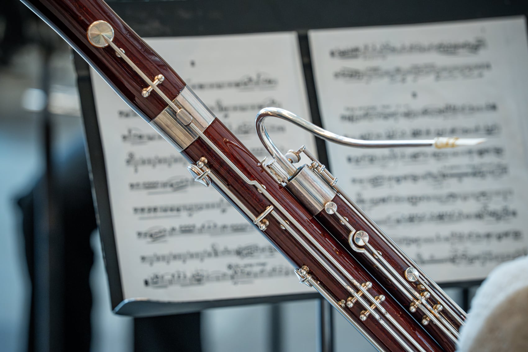 Close up of woodwind instrument in front of sheet music