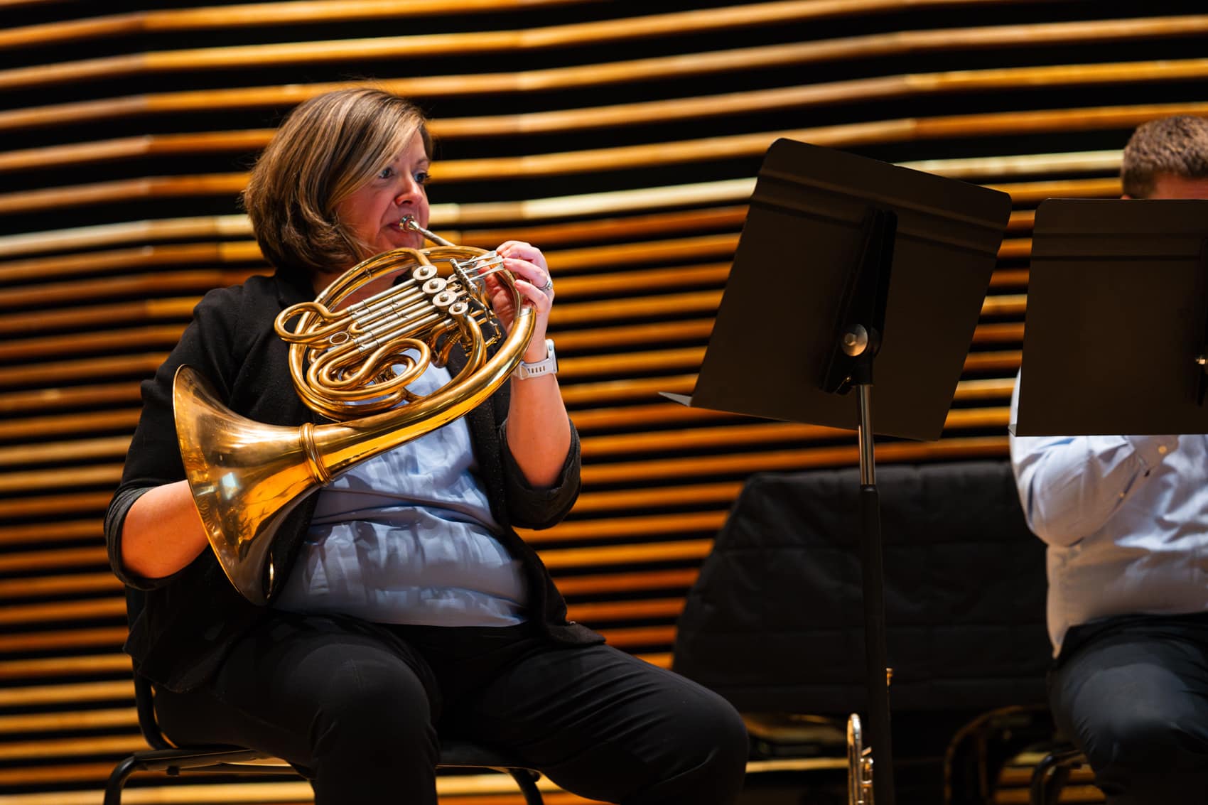 Photo of Katie Johnson Webb playing the french horn.