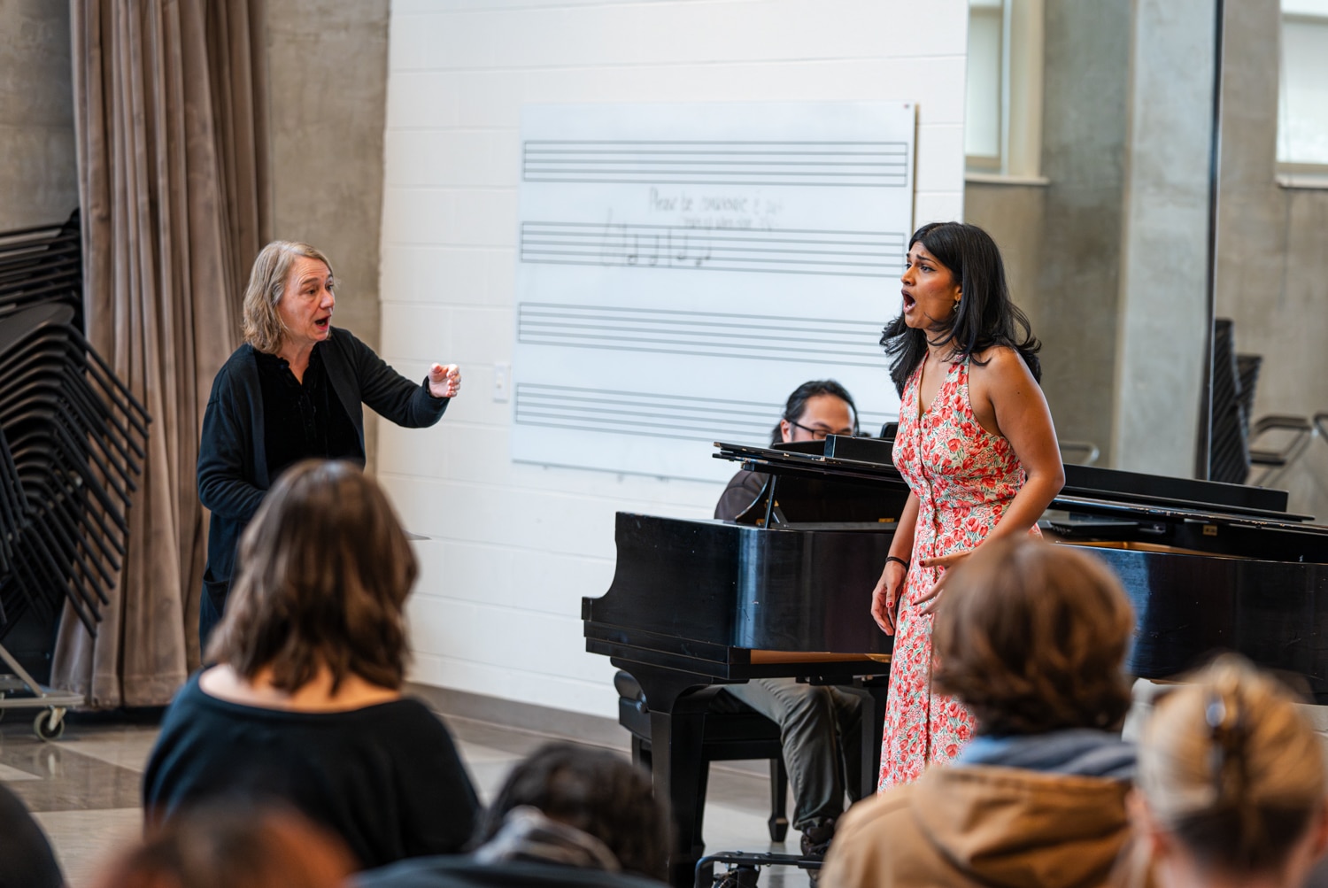 Female guest artist instructs female vocalists during master class