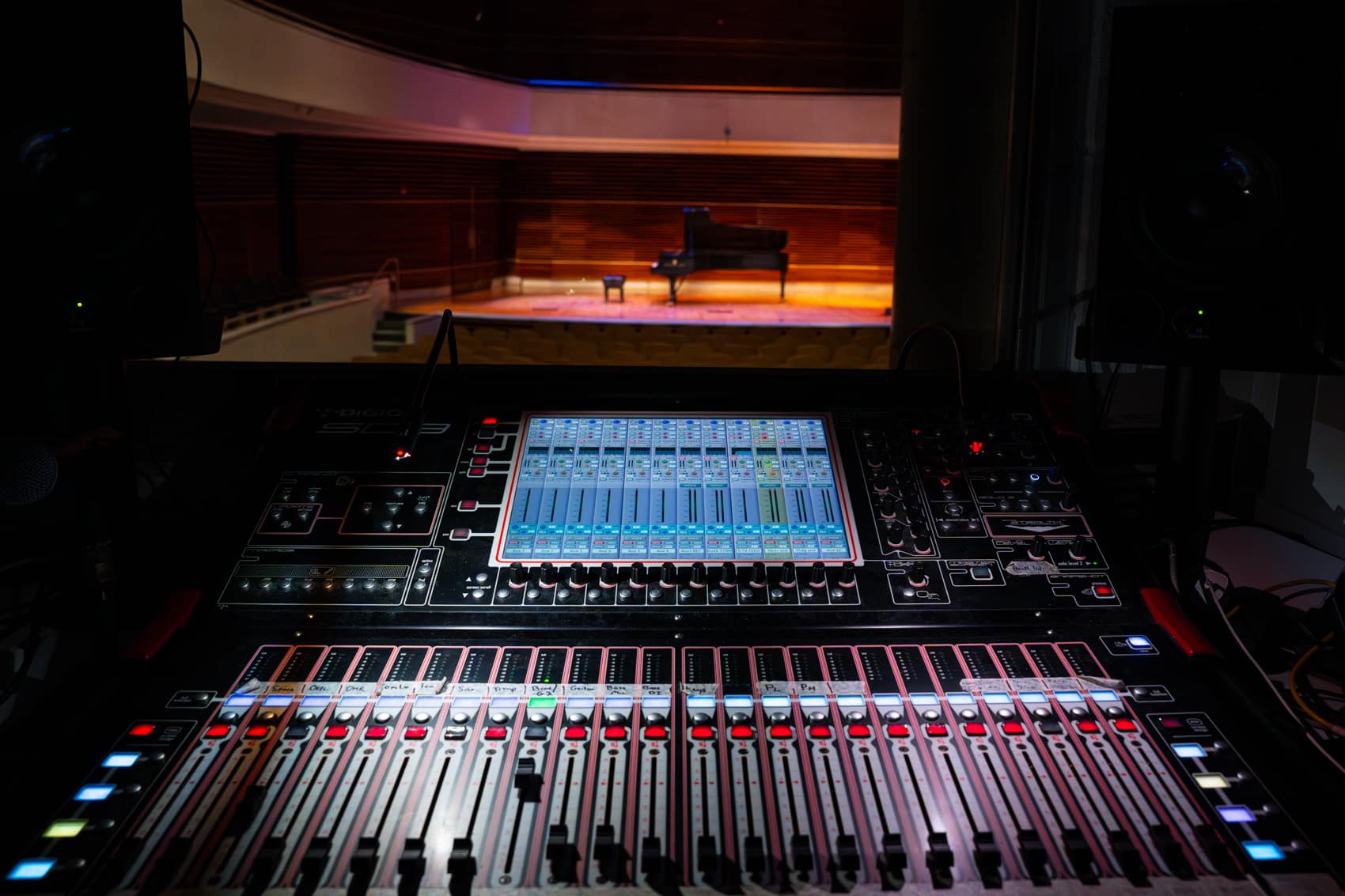 Photo of soundboard with stage through a window