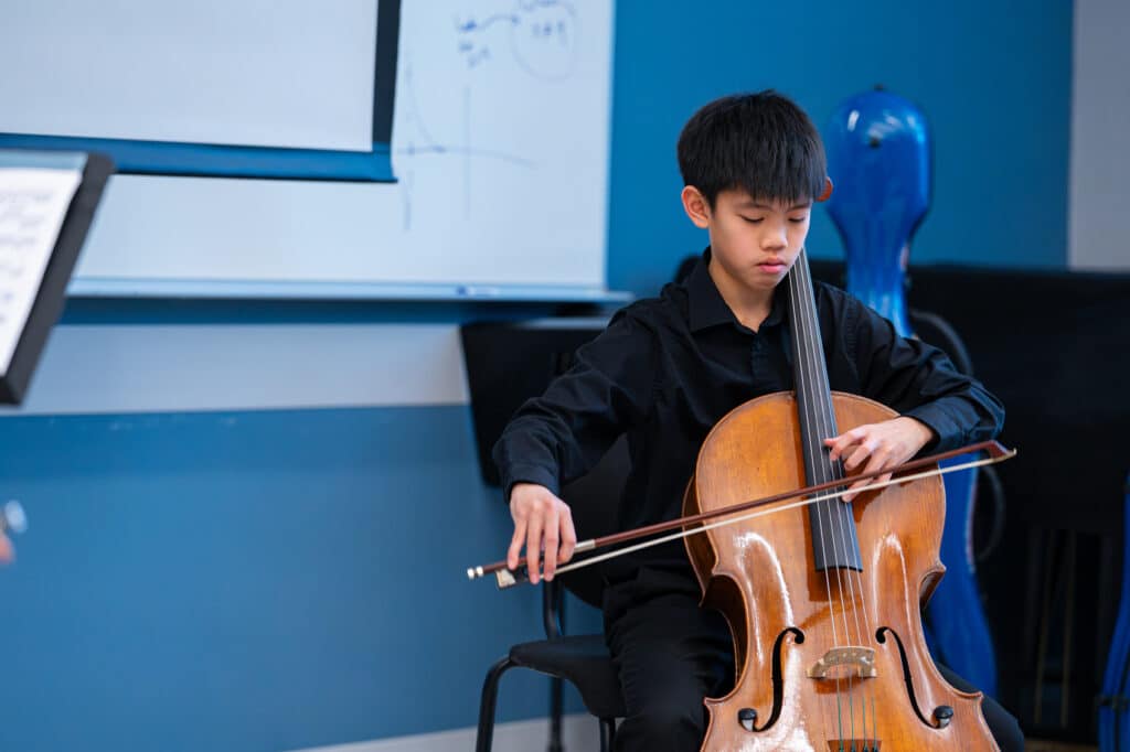Young boy plays the cello