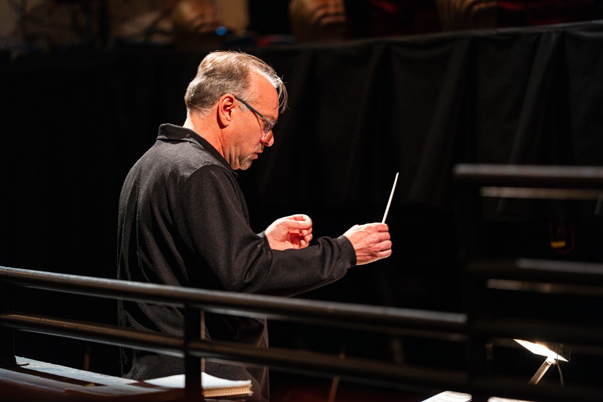 Male conductor with baton