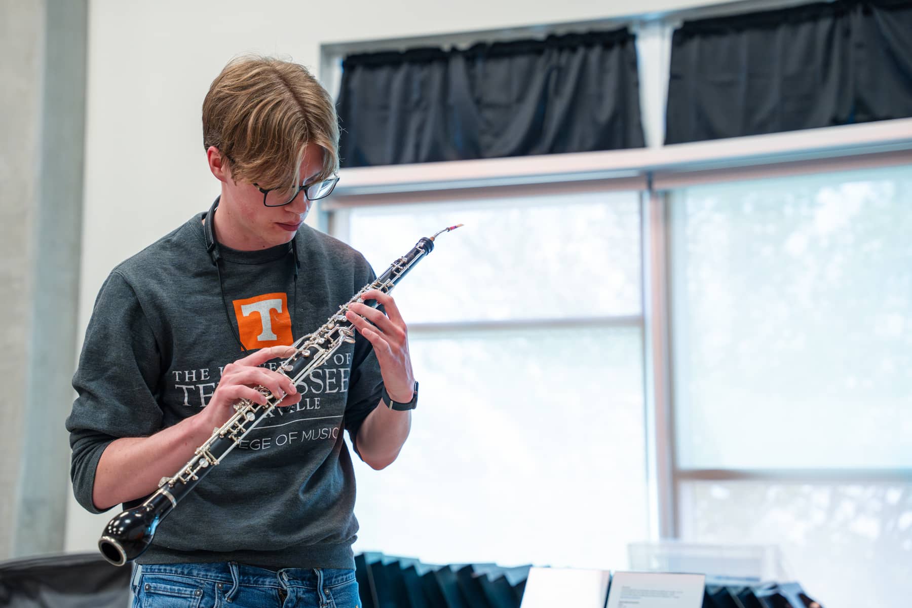 Male student examines oboe