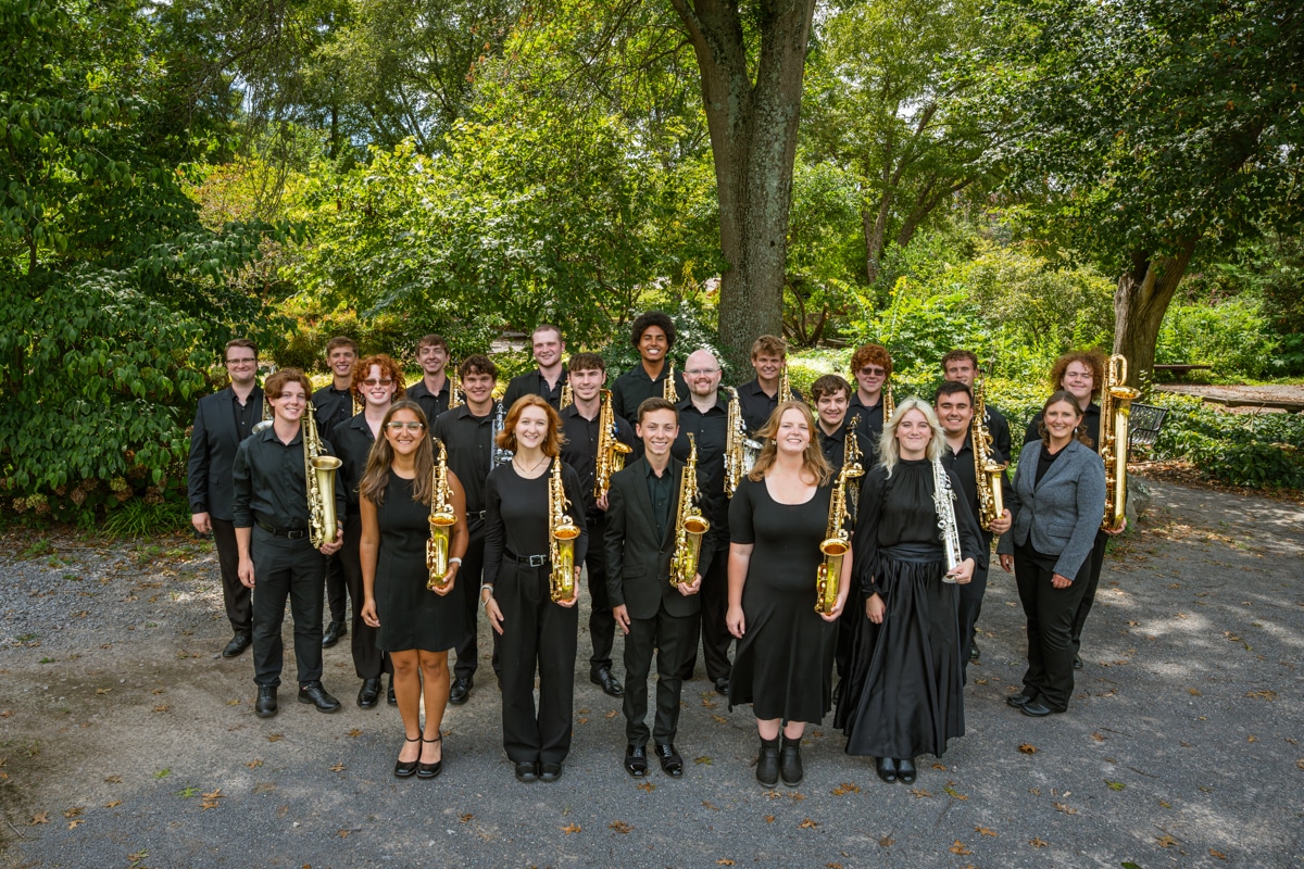 Group of saxophone studio players posing for photo in UT gardens.