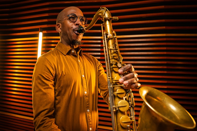 Greg Tardy playing the jazz saxophone on stage close-up.