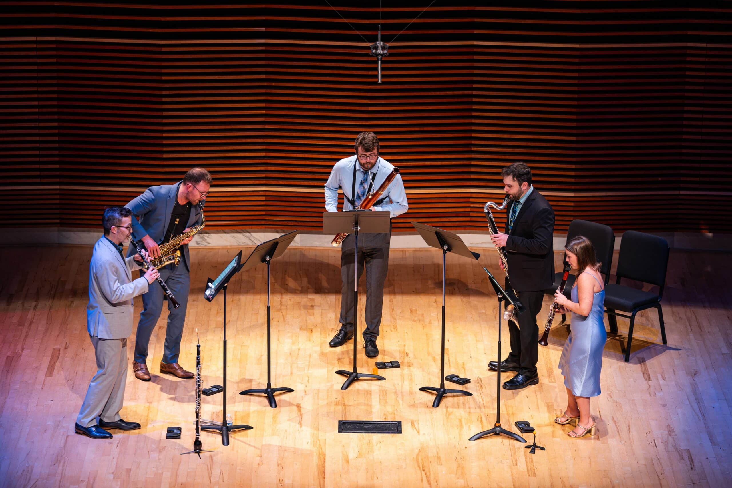 Akropolis Reed Quintet playing in a circle on the Sandra G. Powell Recital Hall.