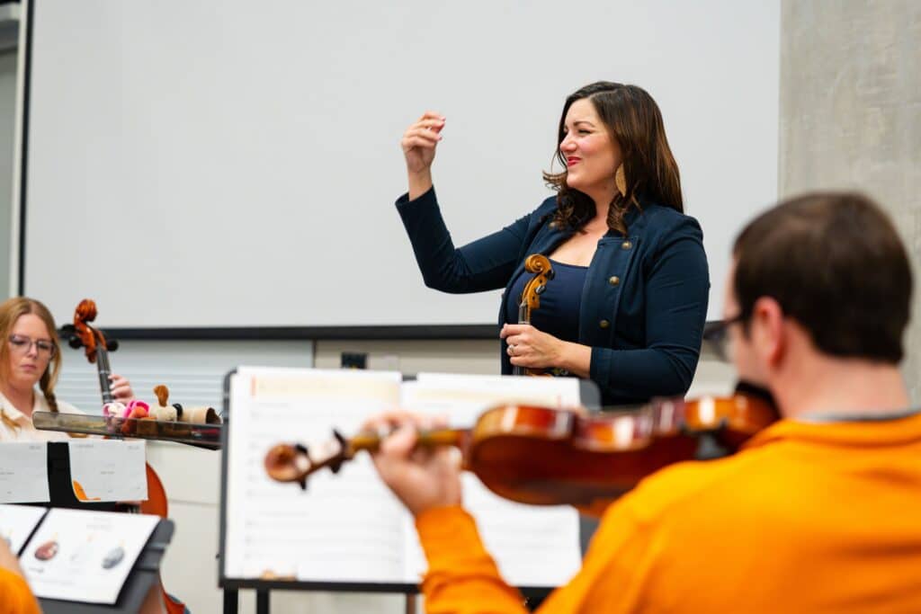 Angela Ammerman, Teaching Associate Professor of Music Education, conducting her strings class.