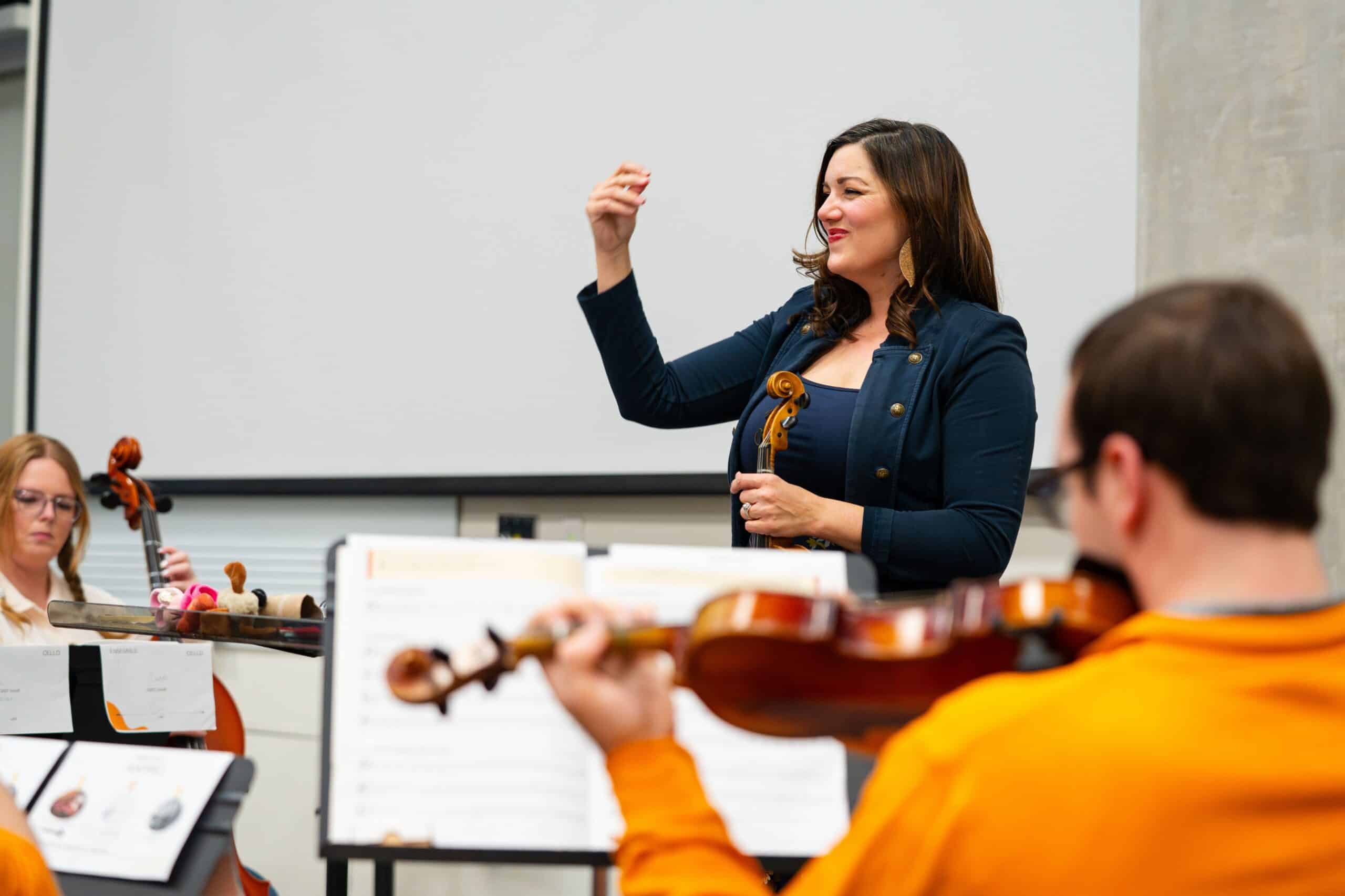 Angela Ammerman, Teaching Associate Professor of Music Education, conducting her strings class.