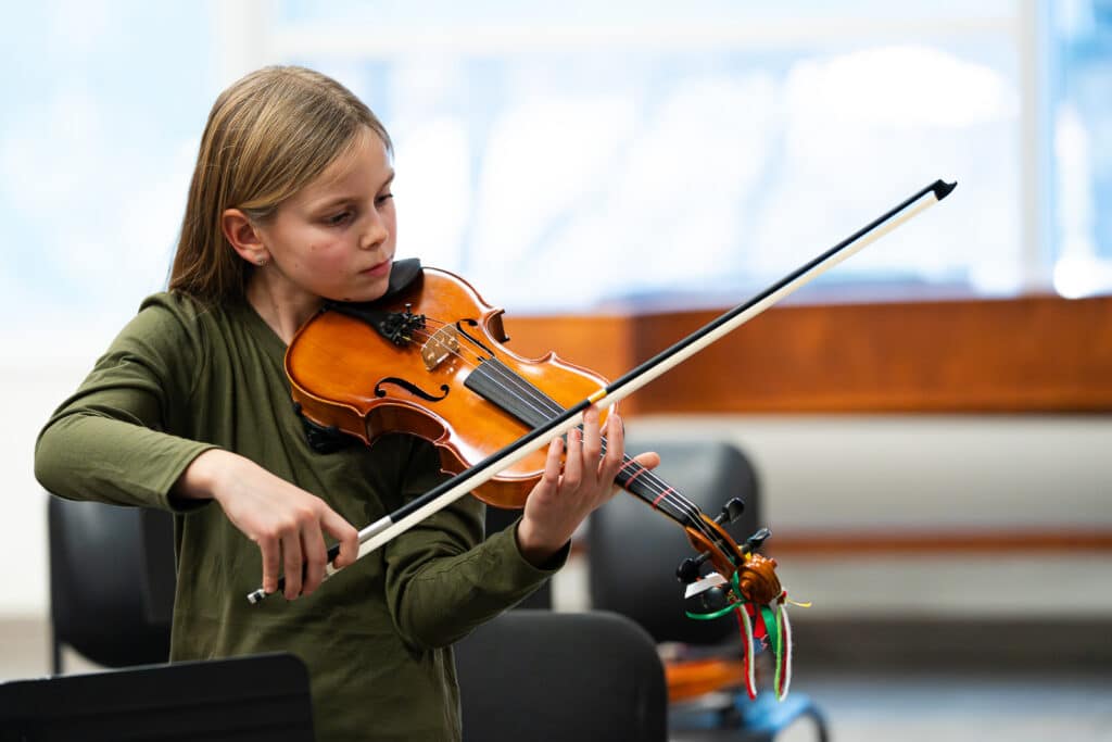Female student playing violin.
